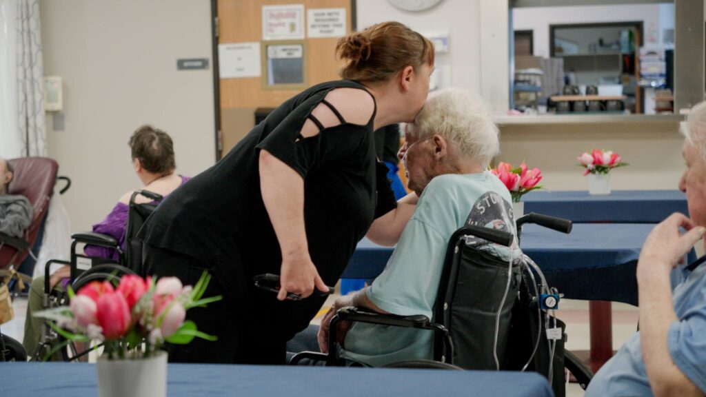 A family member dropping off their loved one for respite care at Care Manor